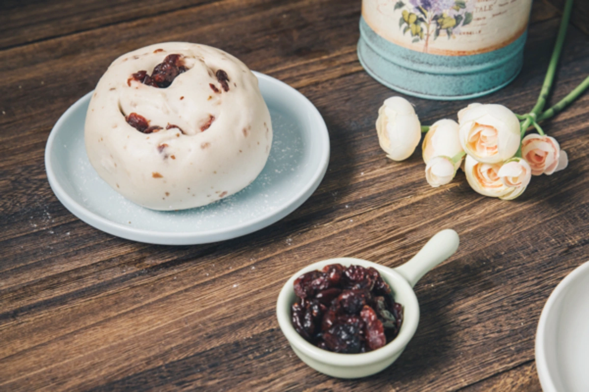 孔子饅頭【有若-鮮奶蔓越莓饅頭】外型特寫，老麵揉製並加入蔓越莓果乾，口感 Q 彈，是酸甜人氣奶素點心。